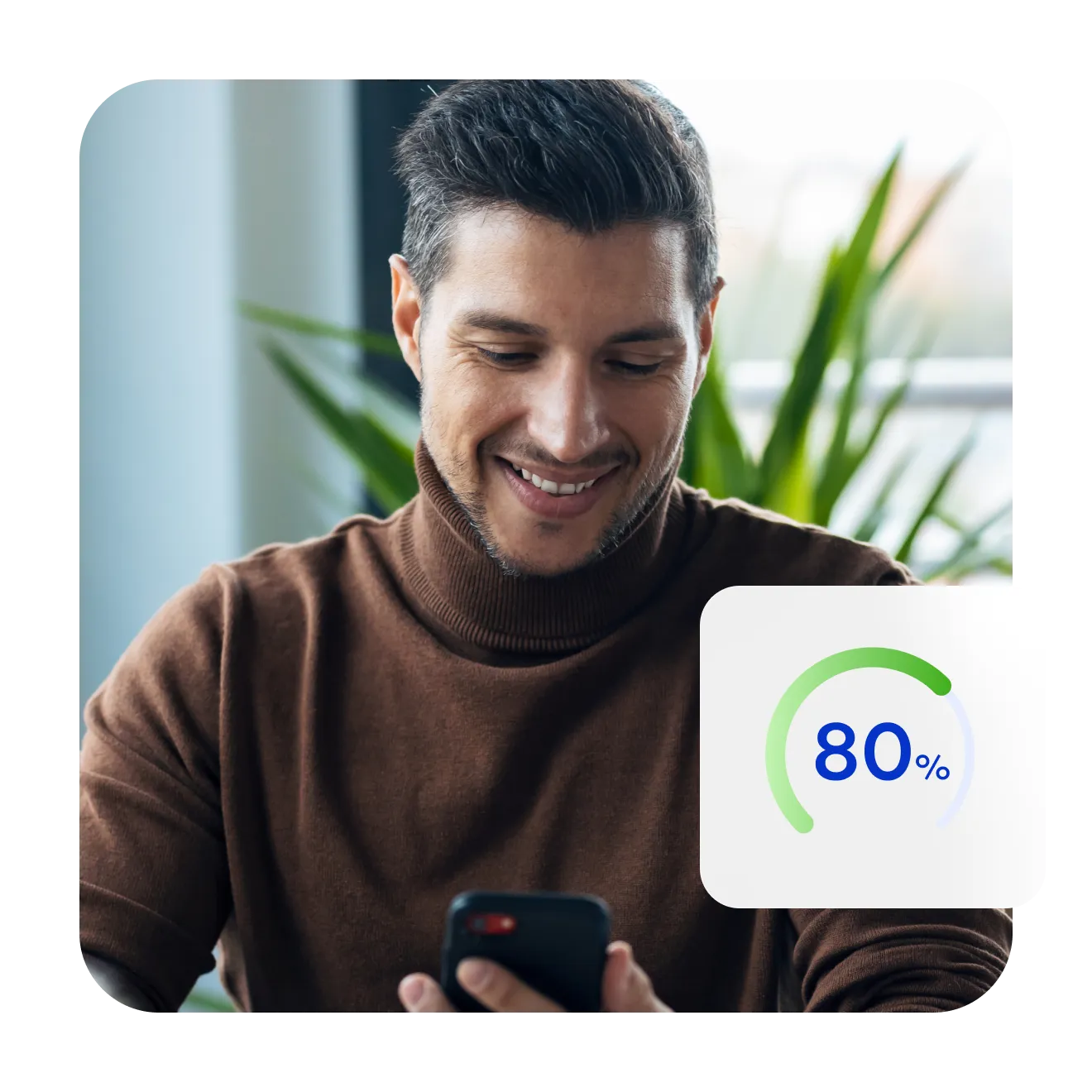 Smiling man looking at his phone, beside a score gauge reading 80%.